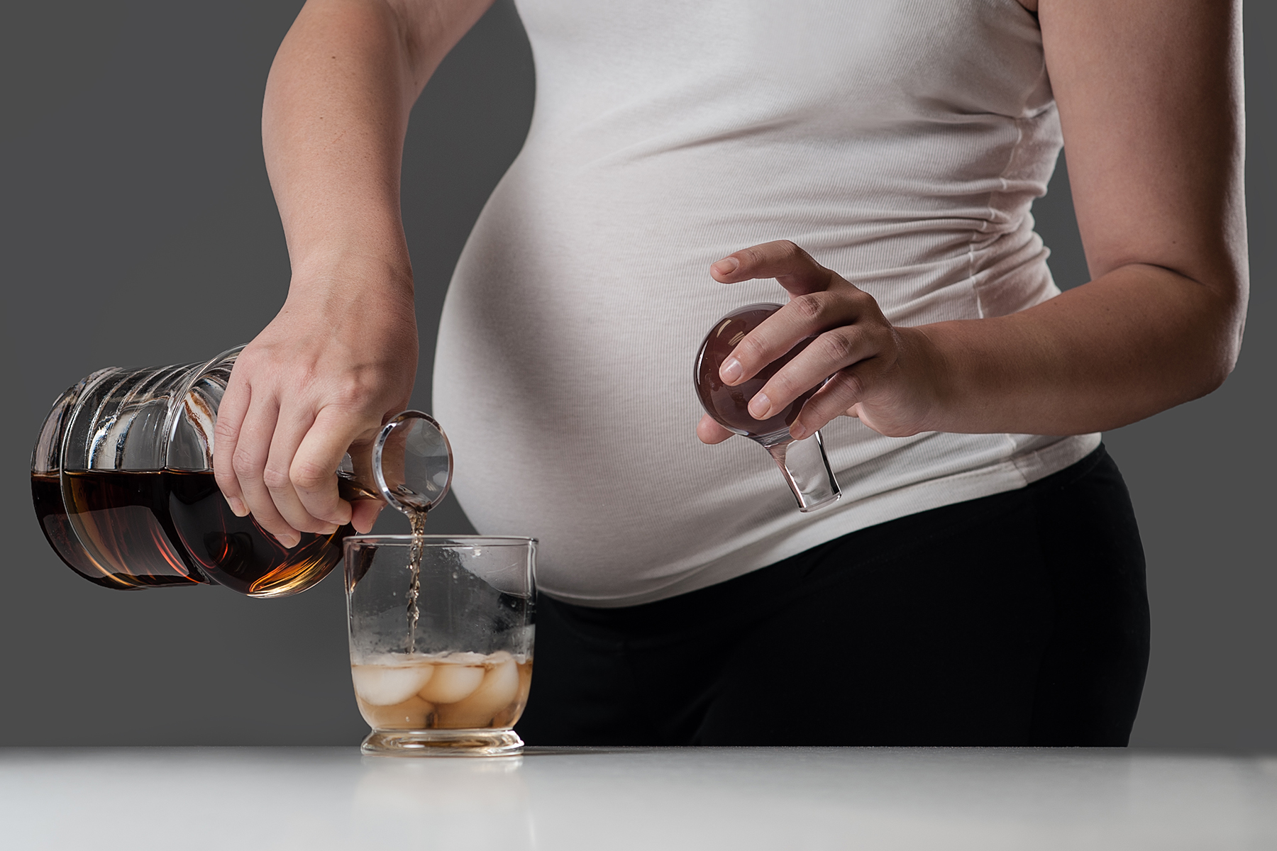 Pregnant woman with alcoholic drink.