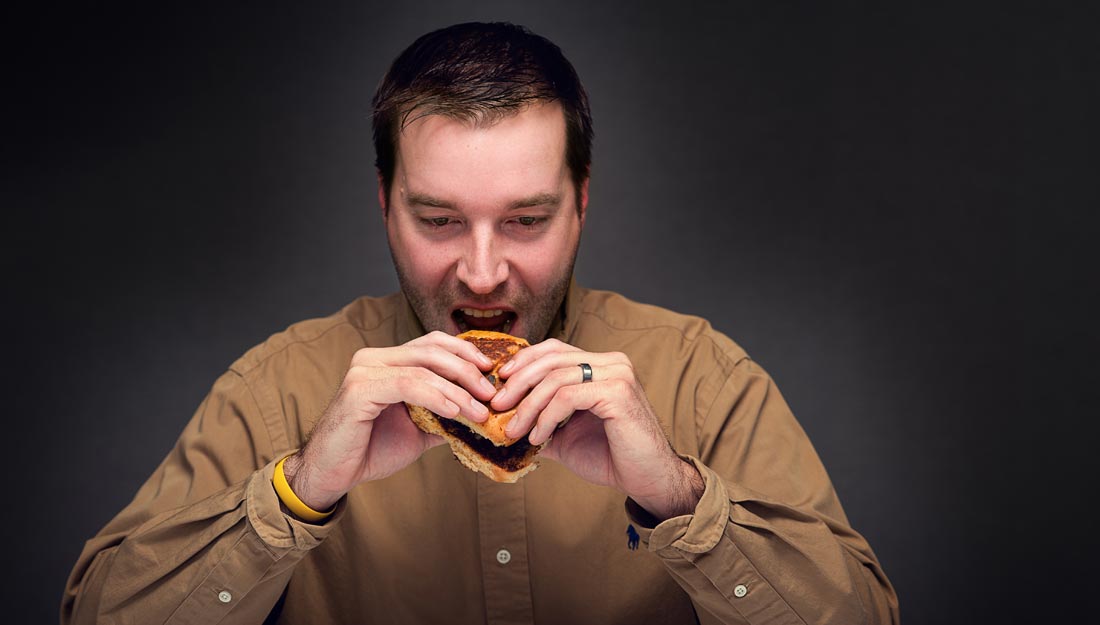 Man eating unhealthy foods