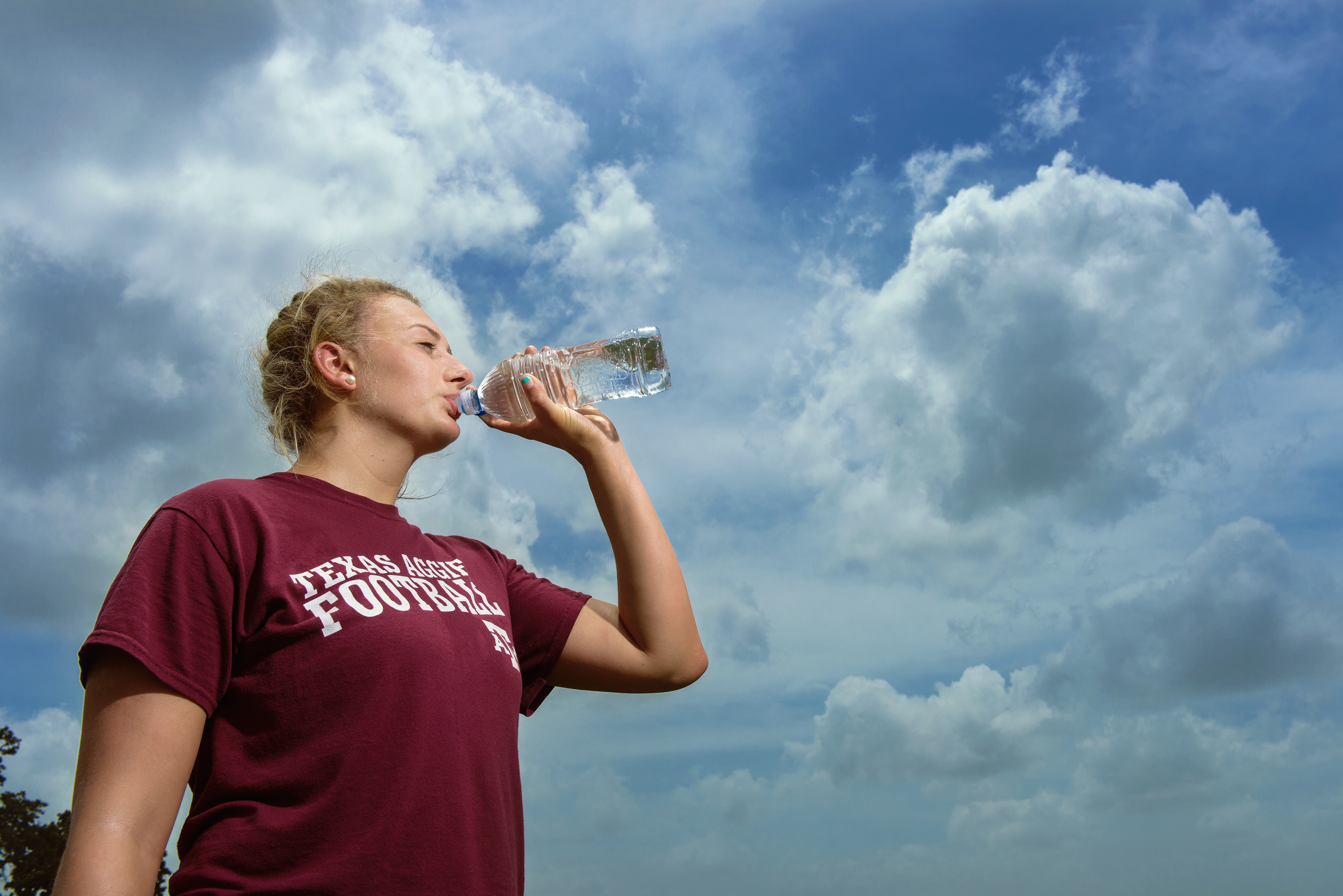 Picture of girl drinking bottled water outside
