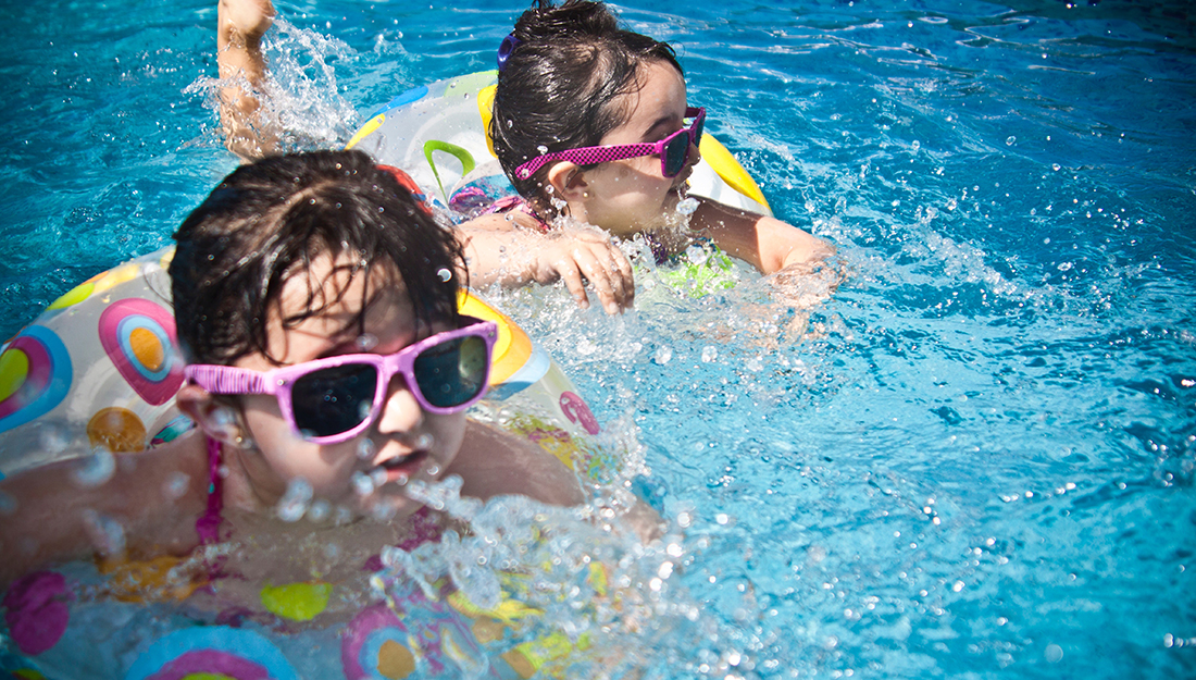 Top 5 injuries and illnesses of the summer-two young girls are swimming with toys and sunglasses on