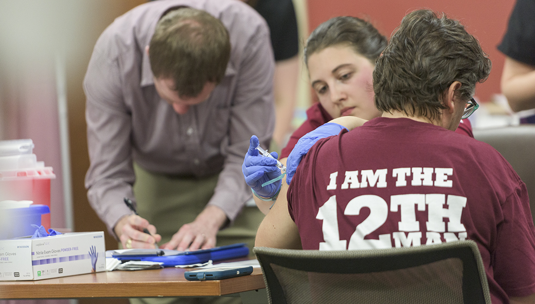 Flu Vaccine Clinic_A student administers a flu shot to a Texas A&M employee