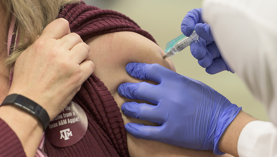 Flu vaccine_Someone is getting a flu shot in their shoulder/upper arm