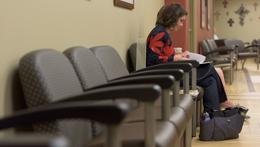 woman sitting in clinic waiting room