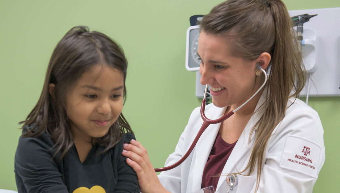 female family nurse practitioner student uses stethoscope to check heart and lung sounds on Hispanic pediatric patient