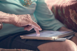 older woman reading on a tablet