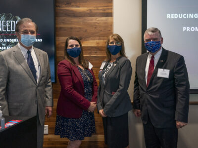 Photo of Chancellor John Sharp, Dr. Jodie Gary, Dr. Nancy Downing and HRSA Administrator Thomas J. Engels standing together with face masks on