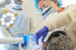 graduate dental students assists professor at an off-site clinic