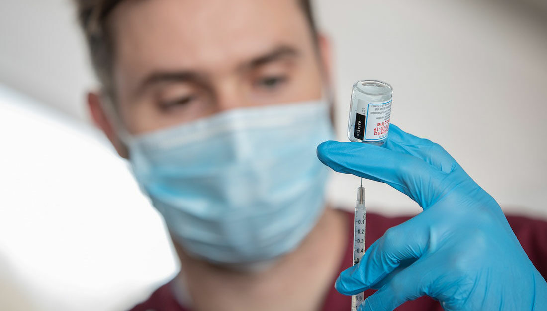 health professional holds a covid-19 vaccine vial