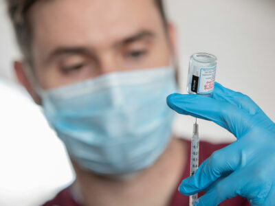 health professional holds a covid-19 vaccine vial
