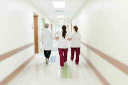 nursing students walk down a hallway