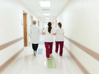 nursing students walk down a hallway