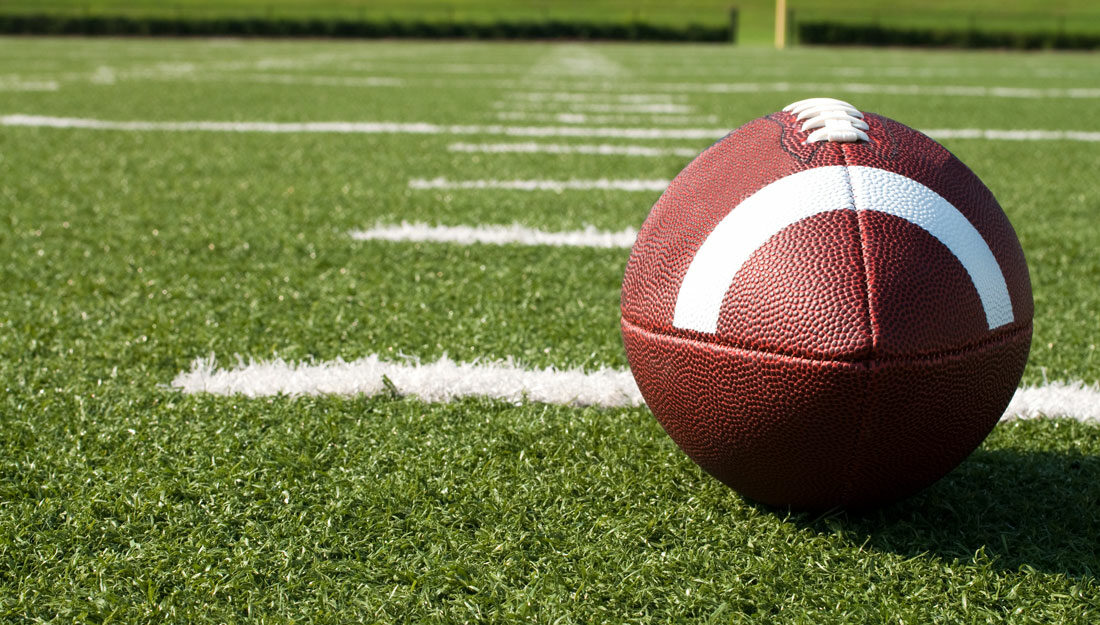 Closeup of American football on field