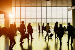 travelers walk through an airport