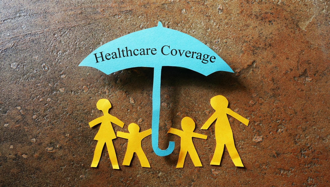 Paper family under paper umbrella with words "Healthcare Coverage"