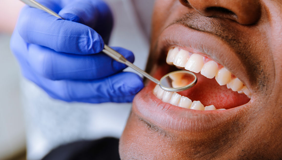 Male patient getting dental treatment in dental clinic